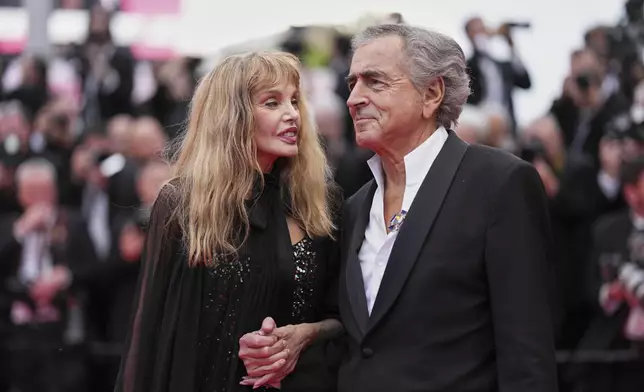 Arielle Dombasle, left, and Bernard-Henri Levy pose for photographers during the opening ceremony red carpet of the 78th international film festival, Cannes, southern France, Tuesday, May 13, 2025. (Photo by Scott A Garfitt/Invision/AP)