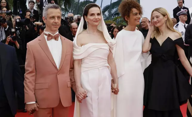 Jury president Juliette Binoche, second from left, and jury members Jeremy Strong, Leila Slimani and Alba Rohrwacher pose for photographers during the opening ceremony red carpet of the 78th international film festival, Cannes, southern France, Tuesday, May 13, 2025. (Photo by Joel C Ryan/Invision/AP)