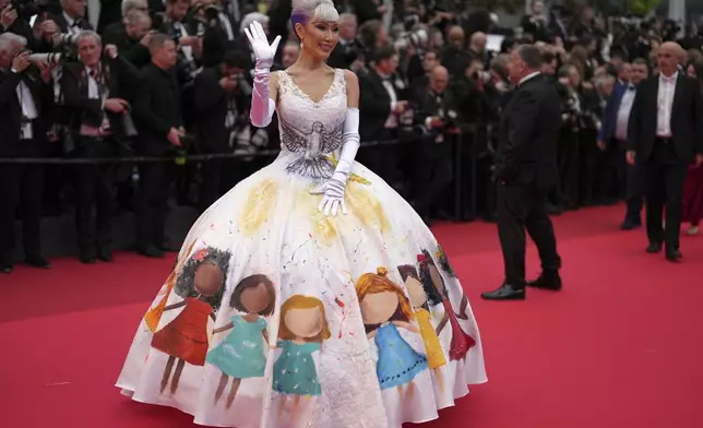 Aliia Roza poses for photographers during the opening ceremony red carpet of the 78th international film festival, Cannes, southern France, Tuesday, May 13, 2025. (AP Photo/Natacha Pisarenko)