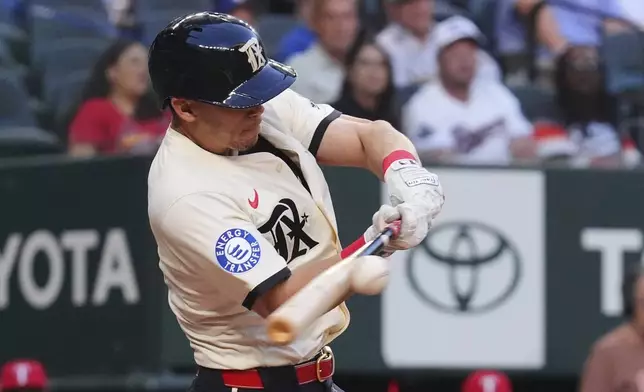 Texas Rangers Sam Haggerty hits a triple scoring teammates Kyle Higashioka and Marcus Semien during the second inning of a baseball game against the St. Louis Cardinals, Friday, May 30, 2025, in Arlington, Texas. (AP Photo/LM Otero)