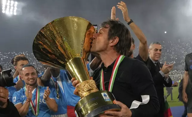 Napoli's head coach Antonio Conte celebrates during the awarding ceremony after winning the Italian league soccer title at the end of the Serie A soccer match between Napoli and Cagliari at the Diego Maradona stadium in Naples, Italy, Saturday, May 24, 2025. (AP Photo/Gregorio Borgia)