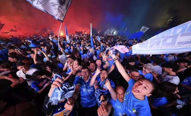 Napoli fans celebrate after winning the Italian league soccer title, in central Naples, Italy, Friday, May 23, 2025. (AP Photo/Salvatore Laporta)