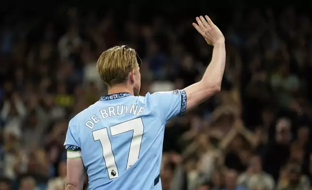 Manchester City's Kevin De Bruyne waves to supporters after his final home game during the English Premier League soccer match between Manchester City and Bournemouth at the Etihad stadium in Manchester, England, Tuesday, May 20, 2025. (AP Photo/Dave Thompson)
