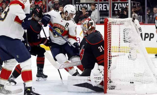 Florida Panthers' Matthew Tkachuk (19) slips the puck past Carolina Hurricanes goaltender Frederik Andersen (31) for a goal during the first period of Game 2 of the NHL hockey Stanley Cup Eastern Conference finals in Raleigh, N.C., Thursday, May 22, 2025. (AP Photo/Karl DeBlaker)