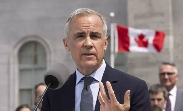 Canadian Prime Minister Mark Carney speaks to the media following a swearing-in ceremony at Rideau Hall in Ottawa, Ontario, Tuesday, May 13, 2025. (Christinne Muschi/The Canadian Press via AP)