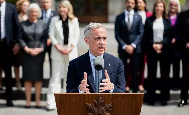 Canada's Prime Minister Mark Carney speaks to reporters following a swearing in ceremony at Rideau Hall in Ottawa, Ontario, Tuesday, May 13, 2025. (Spencer Colby/The Canadian Press via AP)