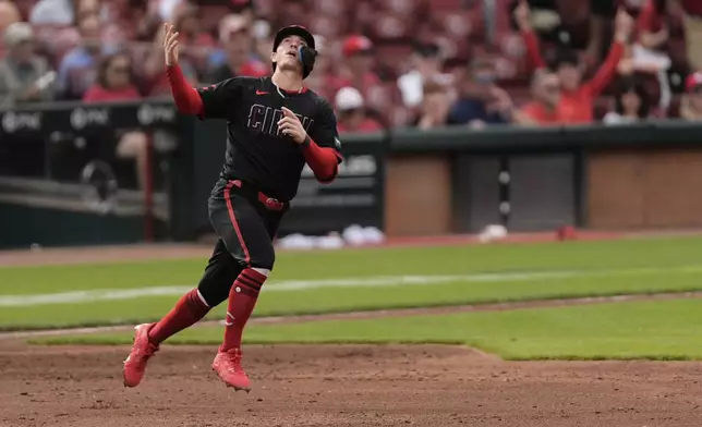Cincinnati Reds' Austin Hays reacts as he rounds the bases after hitting a solo home run in the third inning of a baseball game against the Cleveland Guardians, Friday, May 16, 2025, in Cincinnati. (AP Photo/Carolyn Kaster)