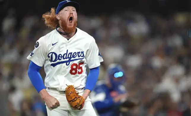 Los Angeles Dodgers starting pitcher Dustin May celebrates after the top of the eighth inning of a baseball game against the Arizona Diamondbacks, Wednesday, May 21, 2025, in Los Angeles. (AP Photo/Mark J. Terrill)