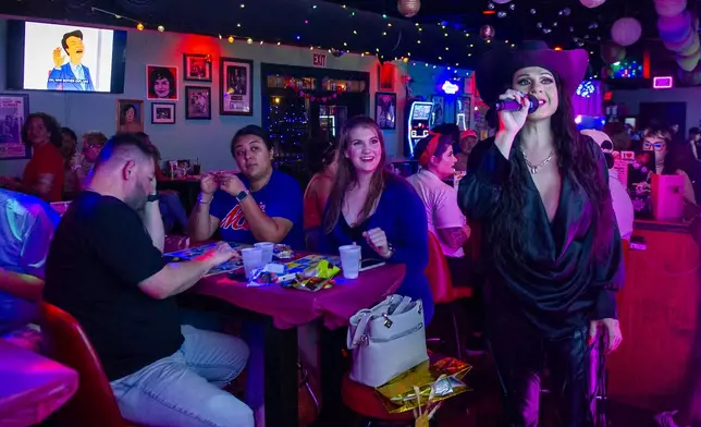 Audrey Campos speaks during a Loteria game night at Jackie O's Cocktail Club in Fort Worth, Texas, Tuesday, May 27, 2025. (AP Photo/Ronaldo Bolaños)