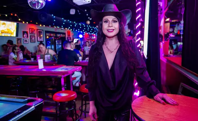 Audrey Campos poses for The Associated Press while hosting a Loteria game night at Jackie O's Cocktail Club in Fort Worth, Texas, Tuesday, May 27, 2025. (AP Photo/Ronaldo Bolaños)