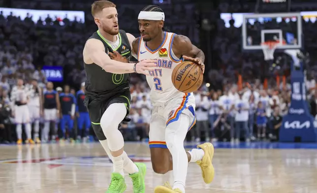 Oklahoma City Thunder guard Shai Gilgeous-Alexander (2) drives against Minnesota Timberwolves guard Donte DiVincenzo (0) during the second half of Game 1 of an NBA basketball Western Conference Finals playoff series Tuesday, May 20, 2025, in Oklahoma City. (AP Photo/Nate Billings)
