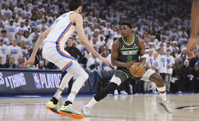Minnesota Timberwolves guard Anthony Edwards (5) works the floor against Oklahoma City Thunder forward Chet Holmgren during the first half of Game 1 of an NBA basketball Western Conference Finals playoff series Tuesday, May 20, 2025, in Oklahoma City. (AP Photo/Nate Billings)