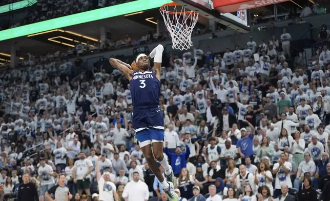 Minnesota Timberwolves forward Jaden McDaniels (3) goes up for a dunk during the second half of Game 2 of an NBA basketball second-round playoff series against the Golden State Warriors, Thursday, May 8, 2025, in Minneapolis. (AP Photo/Abbie Parr)