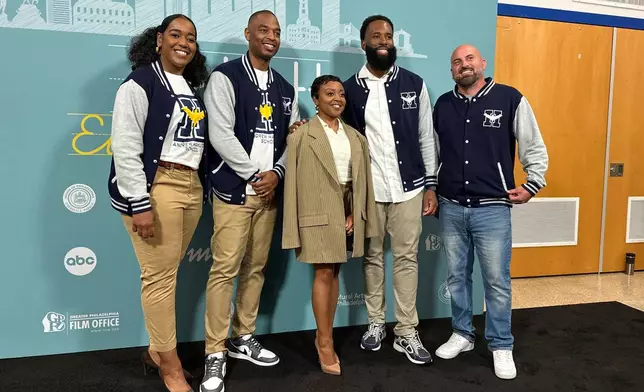 Actor Quinta Brunson, center, poses with unidentified teachers, before receiving a key to the city in a ceremony dedicating a mural at Brunson’s alma mater, Andrew Hamilton School, which was the inspiration for her award-winning show “Abbott Elementary”, Wednesday, May 28, 2025, in Philadelphia. (AP Photo/Tassanee Vejpongsa)