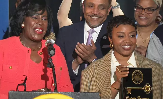 In this image made from video, Philadelphia's Mayor Cherelle Parker, left, honors actor Quinta Brunson with a key to the city in a ceremony dedicating a mural at Brunson’s alma mater, Andrew Hamilton School, which was the inspiration for her award-winning show “Abbott Elementary” Wednesday, May 28, 2025, in Philadelphia. (AP Photo/Tassanee Vejpongsa)