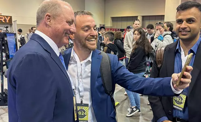FILE - Berkshire Hathaway shareholders line up to take selfies with Greg Abel Friday, May 3, 2024, in Omaha, Neb. (AP Photo/Josh Funk, File)
