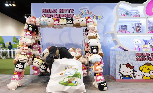 Kevin Gao of San Francisco sorts through his bag of Squishmallows from the Jazwares booth in CHI Health Center Omaha for the Berkshire Hathaway annual meeting Saturday, May 3, 2025, in Omaha, Neb. (AP Photo/Rebecca S. Gratz)