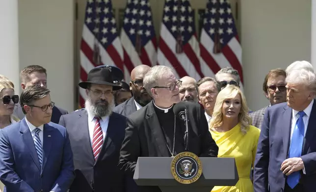 Bishop Robert Barron, with from left front, House Speaker Mike Johnson, Rabbi Levi Shemtov, Barron, Pastor Paula White and President Donald Trump, speaks during a National Day of Prayer event in the Rose Garden of the White House, Thursday, May 1, 2025, in Washington. (AP Photo/Alex Brandon)