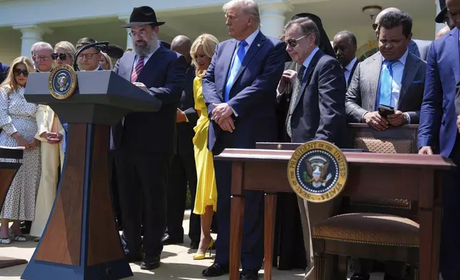Rabbi Levi Shemtov speaks as President Donald Trump, center, listens during a National Day of Prayer event in the Rose Garden of the White House, Thursday, May 1, 2025, in Washington. (AP Photo/Evan Vucci)