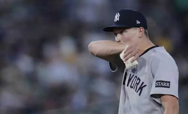 New York Yankees pitcher Will Warren walks to the mound after striking out Athletics' Shea Langeliers during the fourth inning of a baseball game Friday, May 9, 2025, in West Sacramento, Calif. (AP Photo/Godofredo A. Vásquez)