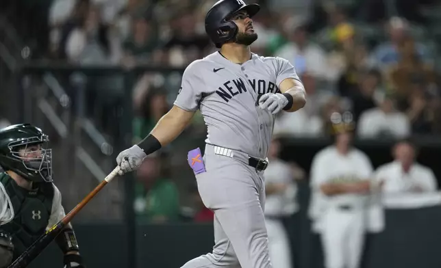 New York Yankees' Jasson Domínguez watches his grand slam during the eighth inning of a baseball game against the Athletics, Friday, May 9, 2025, in West Sacramento, Calif. (AP Photo/Godofredo A. Vásquez)