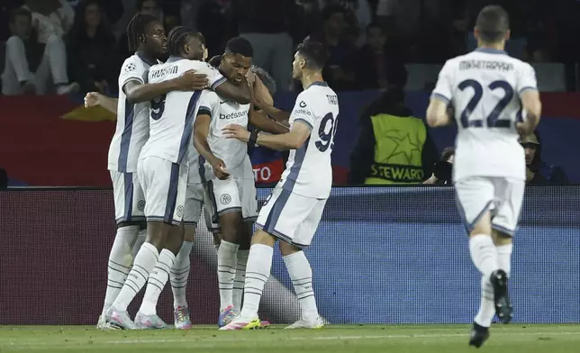Inter Milan's Denzel Dumfries, center, celebrates with his teammates after scoring his side's third goal during the Champions League semifinal first leg soccer match between Barcelona and Inter Milan at the Lluis Companys Olympic Stadium in Barcelona, Spain, Wednesday, April 30, 2025. (AP Photo/Joan Monfort)