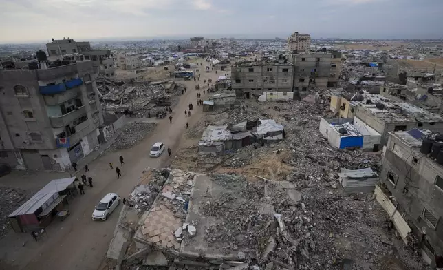 FILE - A tent camp for displaced Palestinians is set up amid destroyed buildings in the Khan Younis refugee camp, southern Gaza Strip, Jan. 4, 2025. (AP Photo/Abdel Kareem Hana, File)