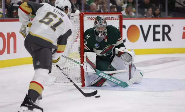 Vegas Golden Knights right wing Mark Stone (61) skates with the puck while Minnesota Wild goaltender Filip Gustavsson defends the net during the second period of Game 6 of a first-round NHL hockey playoff series Thursday, May 1, 2025, in St. Paul, Minn. (AP Photo/Bailey Hillesheim)