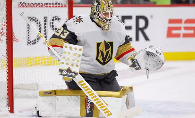 Vegas Golden Knights goaltender Adin Hill watches the play during the first period of Game 6 of a first-round NHL hockey playoff series against the Minnesota Wild, Thursday, May 1, 2025, in St. Paul, Minn. (AP Photo/Bailey Hillesheim)