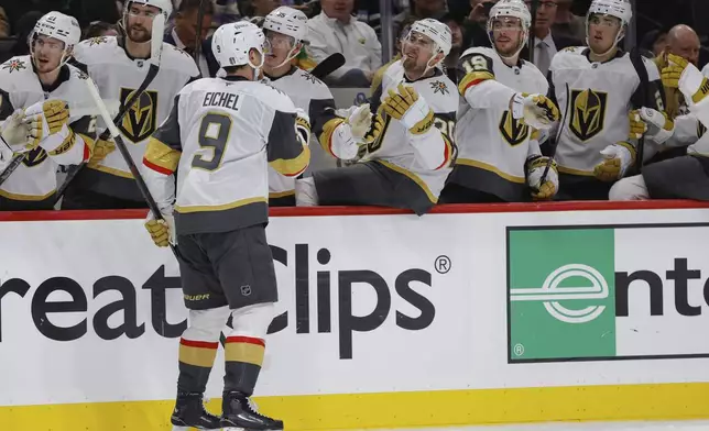 Vegas Golden Knights center Jack Eichel (9) is congratulated by teammates after scoring during the second period of Game 6 of a first-round NHL hockey playoff series against the Minnesota Wild, Thursday, May 1, 2025, in St. Paul, Minn. (AP Photo/Bailey Hillesheim)