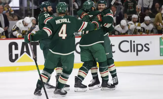 Minnesota Wild right wing Ryan Hartman, right, celebrates with teammates after scoring during the first period of Game 6 of a first-round NHL hockey playoff series against the Vegas Golden Knights, Thursday, May 1, 2025, in St. Paul, Minn. (AP Photo/Bailey Hillesheim)