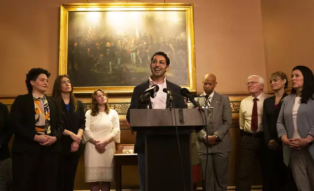 Mohsen Mahdawi, center, speaks during a press conference announcing the launch of the Vermont Immigration Legal Defense Fund in the Cedar Creek Reception Room at the Vermont State House on Thursday, May 8, 2025, in Montpelier, Vt. (AP Photo/Alex Driehaus)
