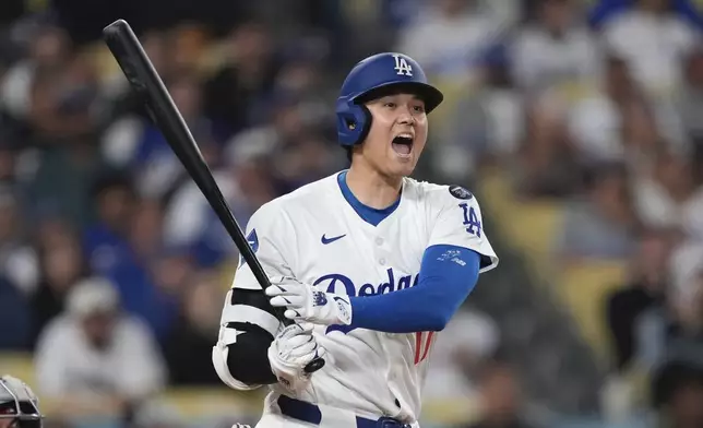 Los Angeles Dodgers' Shohei Ohtani yells as he hits a foul ball during the eighth inning of a baseball game against the Los Angeles Angels, Friday, May 16, 2025, in Los Angeles. (AP Photo/Mark J. Terrill)