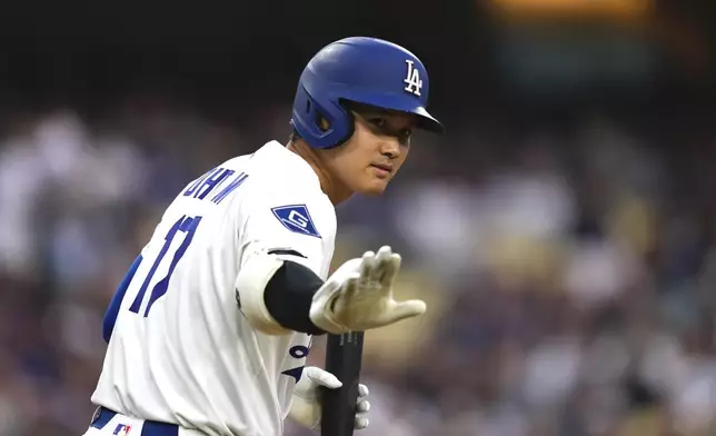Los Angeles Dodgers' Shohei Ohtani gestures toward the Los Angeles Angels dugout before batting during the first inning of a baseball game Friday, May 16, 2025, in Los Angeles. (AP Photo/Mark J. Terrill)