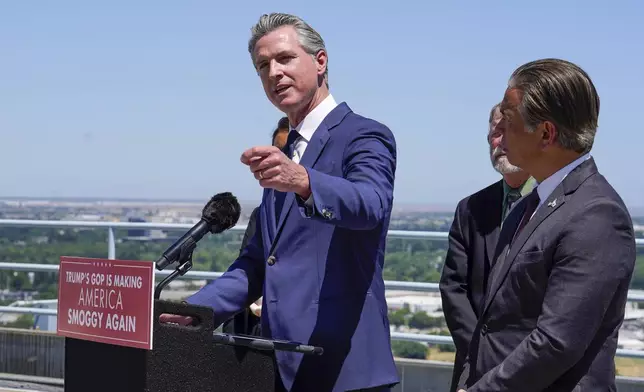Standing atop the Cal. EPA building, Calif. Gov. Gavin Newsom discusses the U.S. Senate 's vote against California Emissions rules which include the ban on the sale of new gas powered cars by 2035. Sacramento, Calif., Thursday May 22, 2025. At right is California Attorney General Rob Bonta. (Photo/Rich Pedroncelli)