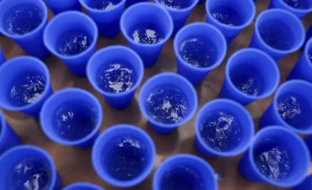 Water is available to runners in Hiccup, reusable silicone cups, during the PNC Women Run the Cities race on Saturday, May 17, 2025, in Minneapolis. (AP Photo/Ellen Schmidt)