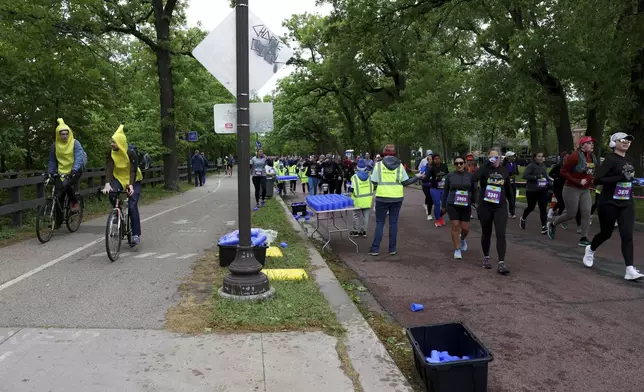 Runners get hydration via Hiccup, a reusable silicone cup, during the PNC Women Run the Cities race on Saturday, May 17, 2025, in Minneapolis. (AP Photo/Ellen Schmidt)