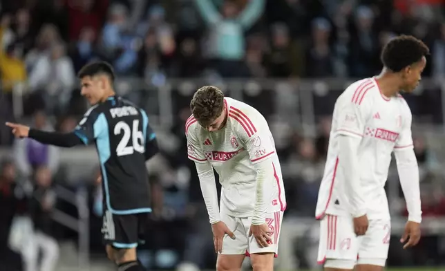 St. Louis City midfielder Jake Girdwood-Reich (3) and defender Akil Watts, right, react after a goal by Minnesota United midfielder Joaquin Pereyra (26) during the second half of an MLS soccer match Saturday, May 17, 2025, in St. Paul, Minn. (AP Photo/Abbie Parr)