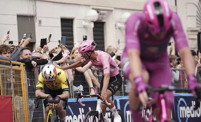 Mexico's Isaac Del Toro of Uae Team Emirates, centre, and Belgium's Wout van Aert of UCI WorldTeam Visma–Lease a Bike, left, compete during the 13th stage of the Giro d'Italia cycling race from Rovigo to Vicenza, Italy, Friday, May 23, 2025. (Marco Alpozzi/LaPresse via AP)