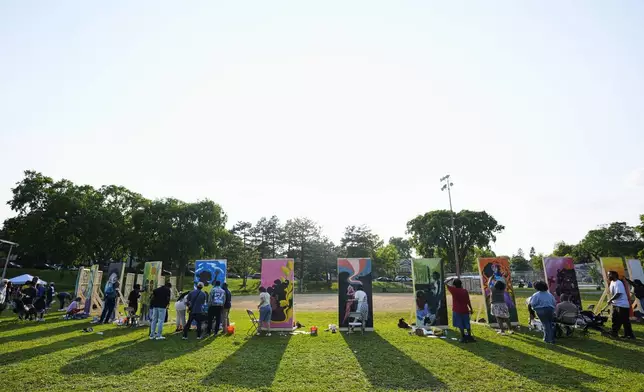People work on paintings in a park near George Floyd Square on the five-year anniversary of Floyd's death, Sunday, May 25, 2025, in Minneapolis. (AP Photo/Abbie Parr)