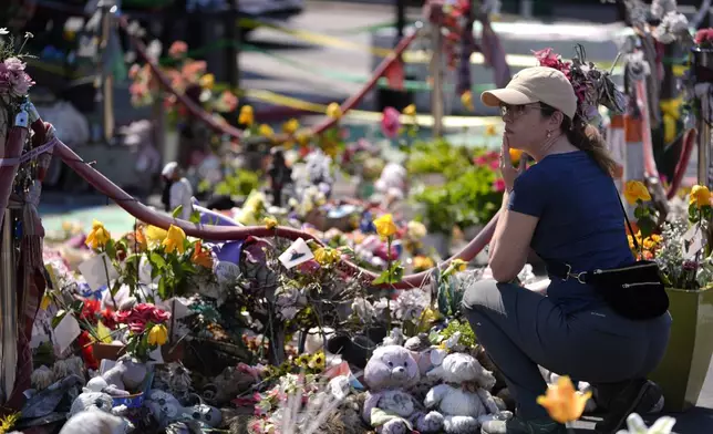 A person visits the spot of George Floyd's murder at George Floyd Square on the five-year anniversary of Floyd's death, Sunday, May 25, 2025, in Minneapolis. (AP Photo/Abbie Parr)