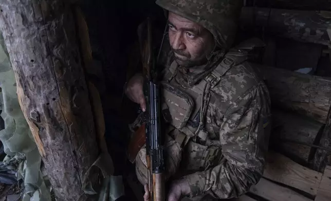 FILE - In this photo provided by Ukraine's 93rd Kholodnyi Yar Separate Mechanized Brigade press service, a soldier looks out of a shelter on the anti-drone firing position in Kostyantynivka, the site of the heavy battles with the Russian troops in the Donetsk region, Ukraine, April 24, 2025. (Iryna Rybakova/Ukraine's 93rd Mechanized Brigade via AP, File)