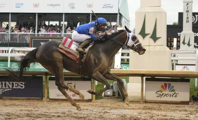 Good Cheer ridden by Luis Saez crosses the finish line to win the 151st running of the Kentucky Oaks horse race at Churchill Downs Friday, May 2, 2025, in Louisville, Ky. (AP Photo/Jeff Roberson)