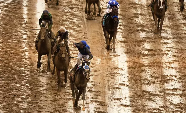 Good Cheer, bottom, ridden by Luis Saez crosses the finish line to win the 151st running of the Kentucky Oaks horse race at Churchill Downs Friday, May 2, 2025, in Louisville, Ky. (AP Photo/Charlie Riedel)