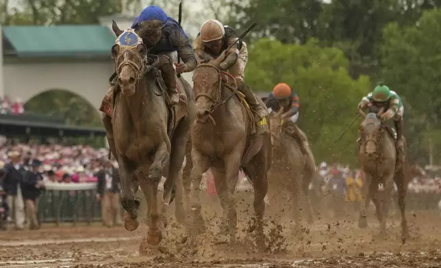 Good Cheer ridden by Luis Saez, left, heads for the finish line to win the 151st running of the Kentucky Oaks horse race at Churchill Downs Friday, May 2, 2025, in Louisville, Ky. (AP Photo/Abbie Parr)