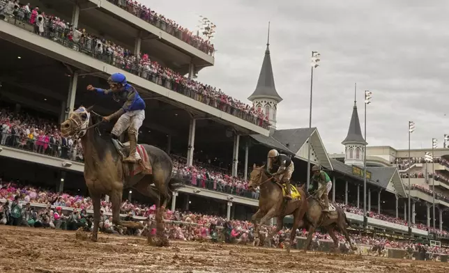 Good Cheer ridden by Luis Saez, left, crosses the finish line to win the 151st running of the Kentucky Oaks horse race at Churchill Downs Friday, May 2, 2025, in Louisville, Ky. (AP Photo/Abbie Parr)