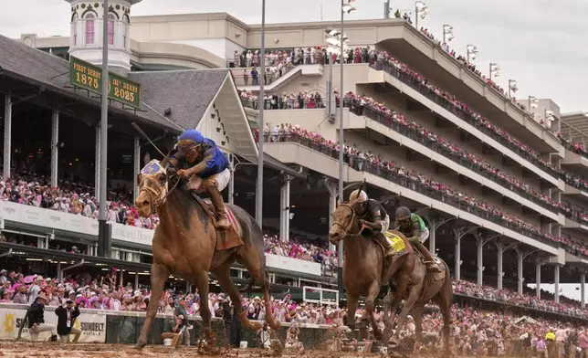 Good Cheer ridden by Luis Saez, left, crosses the finish line to win the 151st running of the Kentucky Oaks horse race at Churchill Downs Friday, May 2, 2025, in Louisville, Ky. (AP Photo/Abbie Parr)