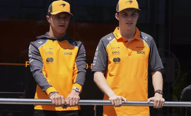 McLaren driver Lando Norris of Britain. left and McLaren driver Oscar Piastri of Australia talk to media before the first free practice at the Enzo and Dino Ferrari racetrack, ahead the Italy's Emilia Romagna Formula One Grand Prix, in Imola, Italy, Friday, May 16, 2025. (AP Photo/Antonio Calanni)