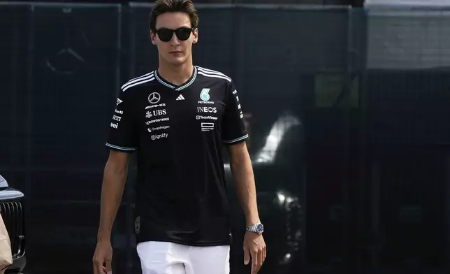 Mercedes driver George Russell of Britain arrives prior to the first free practice at the Enzo and Dino Ferrari racetrack, ahead the Italy's Emilia Romagna Formula One Grand Prix, in Imola, Italy, Friday, May 16, 2025. (AP Photo/Luca Bruno)