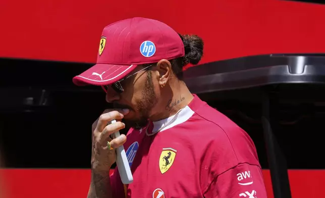 Ferrari driver Lewis Hamilton of Britain arrives prior to the first free practice at the Enzo and Dino Ferrari racetrack, ahead the Italy's Emilia Romagna Formula One Grand Prix, in Imola, Italy, Friday, May 16, 2025. (AP Photo/Luca Bruno)